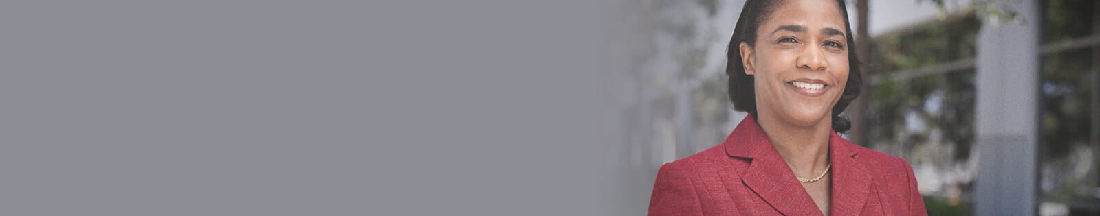 female faculty standing outside daytime smiling
