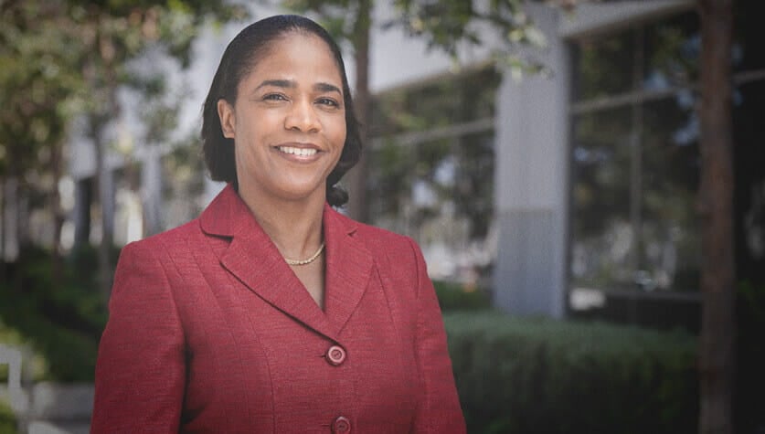 female_faculty_standing_outside_daytime_smiling