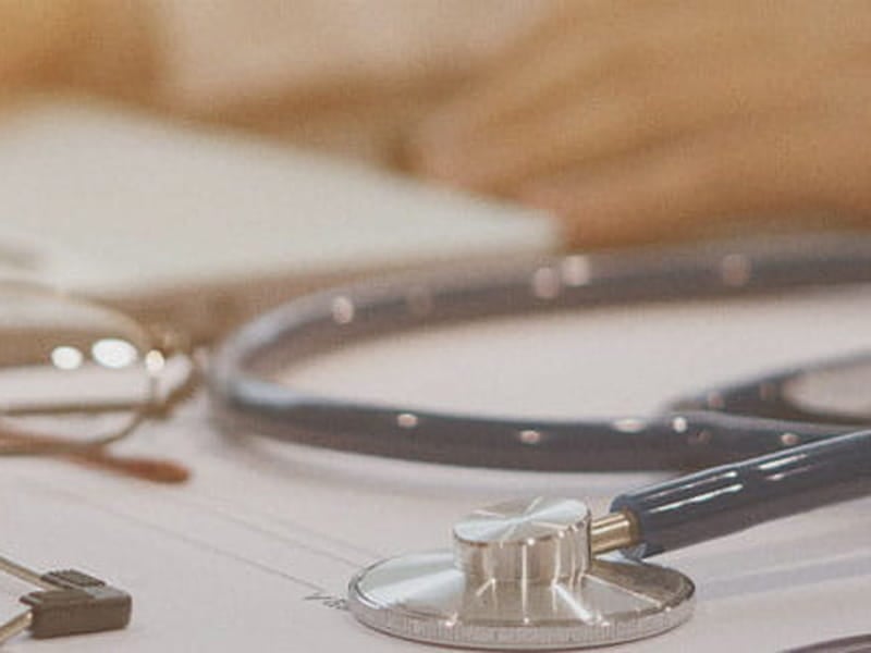 A stethoscope laying on a clipboard.