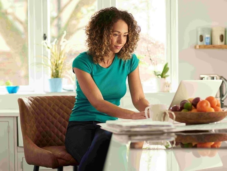 UMass Global Older Student Studying In Kitchen