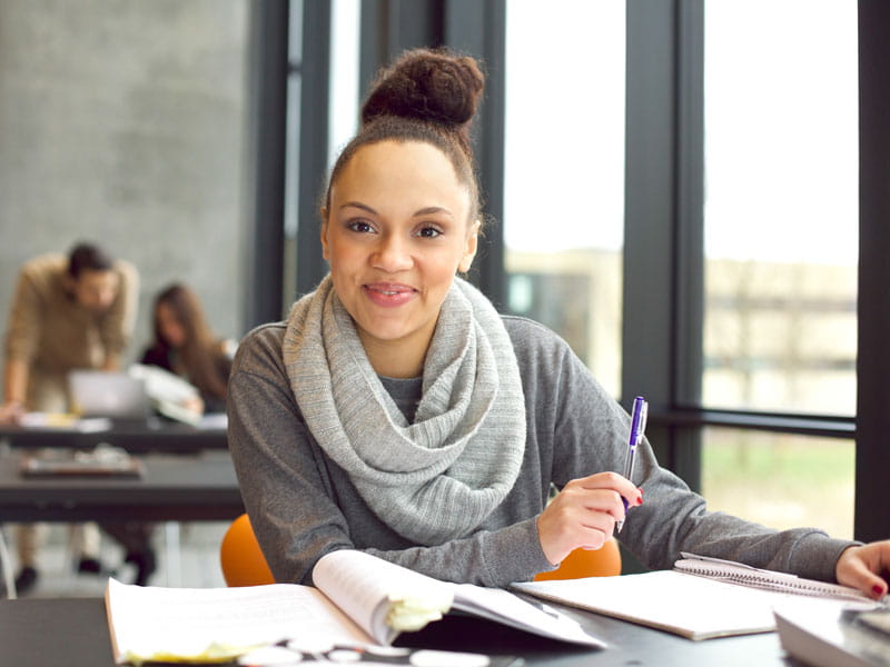 Young female transfer student studying.