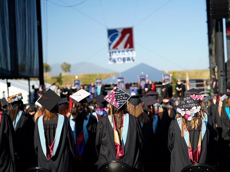 Students at commencement watching the stage.