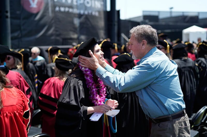a father showing his pride his daughters graduation