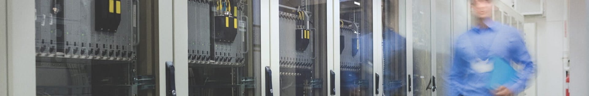 male information technology faculty walking in server room