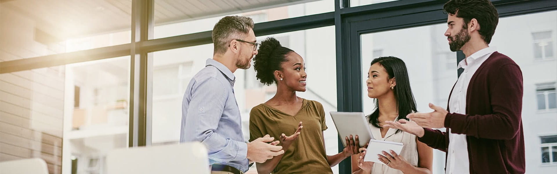 A group of people discussing things in the office.