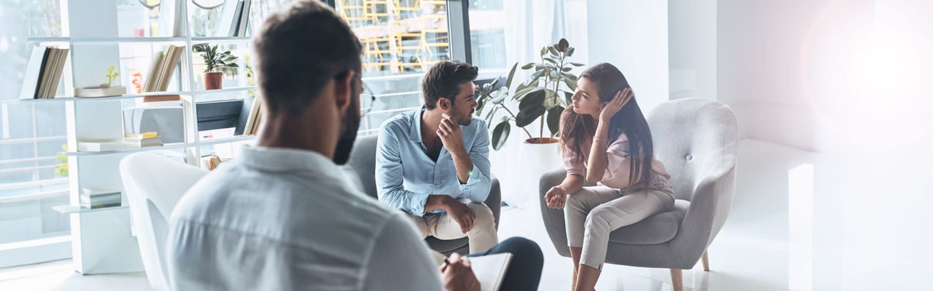 male counselor helping a couple in therapy