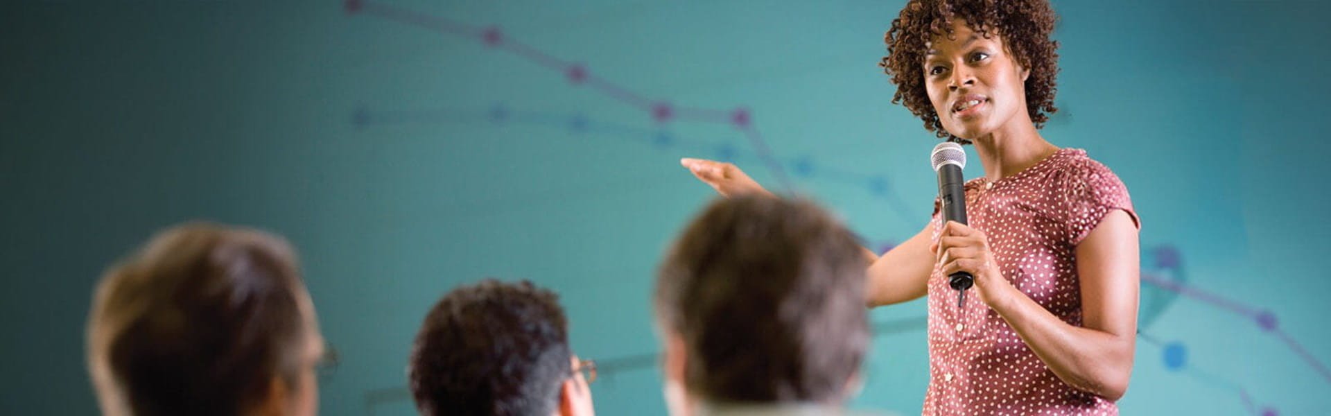 female organizational leadership faculty explaining line graph to students