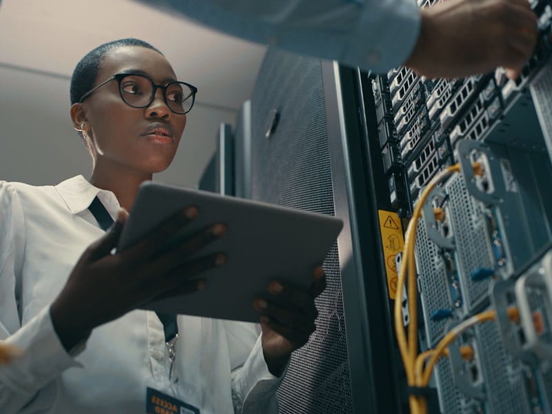 a black woman working on a computer server