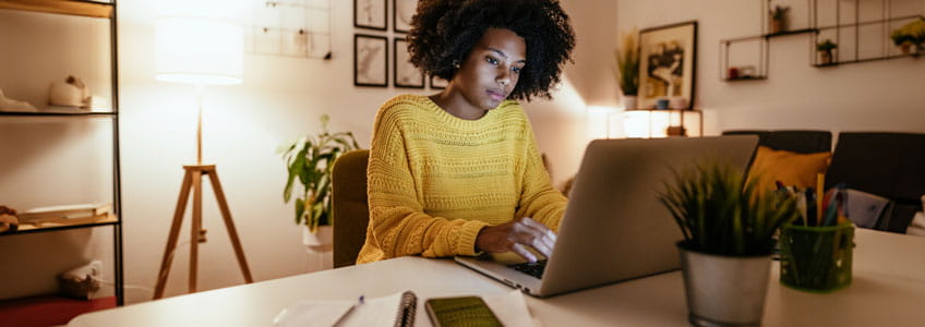 a woman sitting infront of her laptop