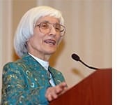 A photo of activist Bernice Sandler speaking into a microphone.