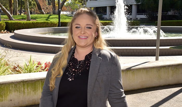 A portrait of Class of 2021 graduation candidate Doreen Temple with a fountain in the background.