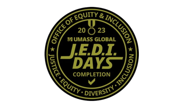 A round gold and black emblem is pictured with the text, "Office of Equity & Inclusion. Justice. Equity. Justice. Inclusion" on the outer rim. On the inside reads the text, "2023 UMass Global J.E.D.I. Days Completion"