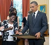 A photo of Lois Curtis, artist and plaintiff in a significant Supreme Court case focused on disabled individuals' rights with President Obama.