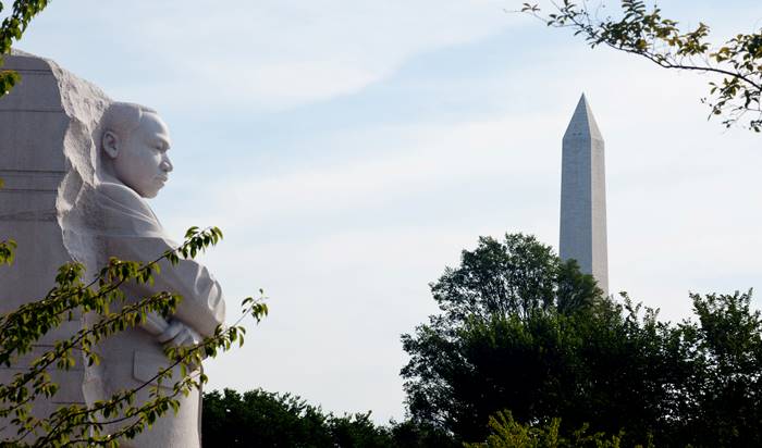 A side view of the Martin Luther King Jr. Memorial with the Washington Monument to the right in the background.