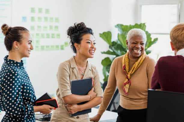 A group of diverse female employees sharing a moment.