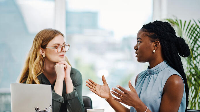 female human resources employee talking to a co-worker