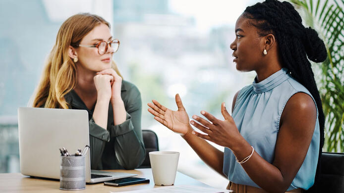 female human resources employee talking to a co-worker