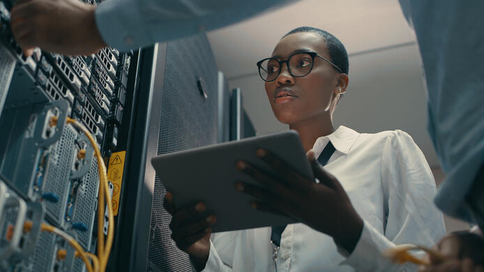 Two technicians in a server room