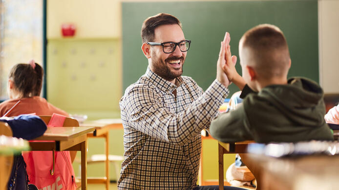 Elementary teacher in classroom with students