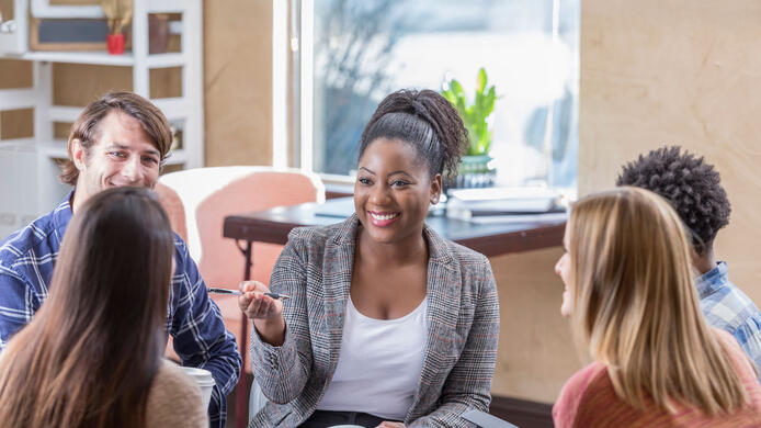 Counselor with young adults in a group conversation