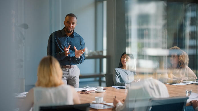 Businessman, meeting and discussion with office, boardroom and collaboration or workshop. Leader, training and presentation for mentor, coaching and strategy for teamwork and planning with startup