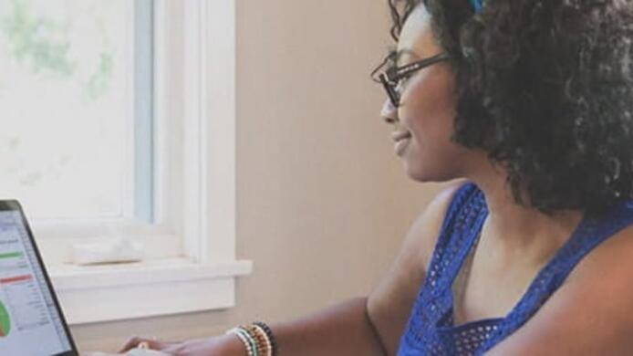 female_student_studying_by_window_at_home_daylight