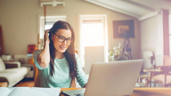 A happy student studying at home.