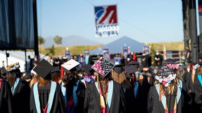 Students at commencement watching the stage.