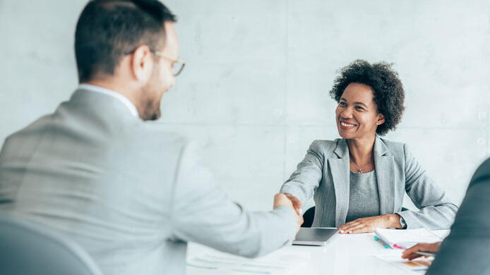 Human Resources manager shaking the hand of a future employee