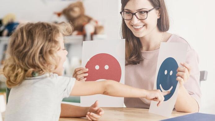 psychologist working with a child on identifying emotions