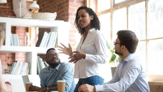 woman talking to group of people