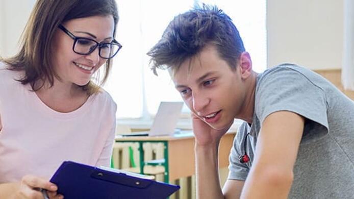 a social worker woman talking to a teenager boy