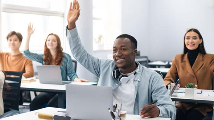 a man raising his hand in a class