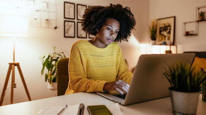 a woman sitting infront of her laptop