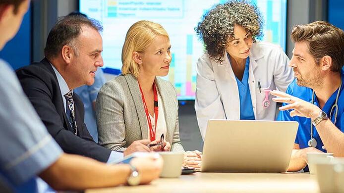 healthcare professional talking to other professionals