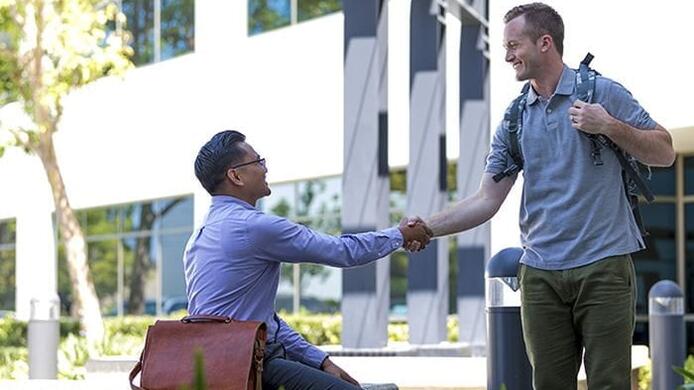 Two students shaking hands
