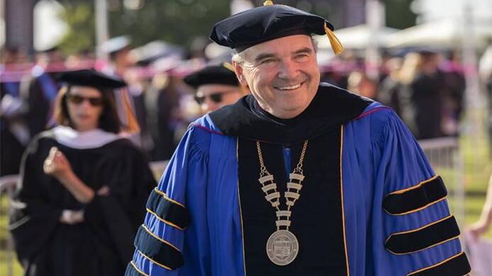 UMass Global Chancellor Dr. David Andrews wearing academic regalia during Southern California Commencement 2022.