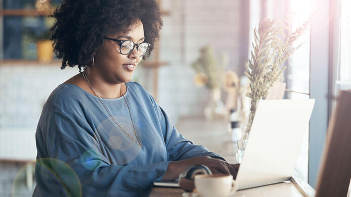 Online student on laptop in front of window
