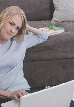 female_student_studying_on_living_room_floor_with_laptop_1_389