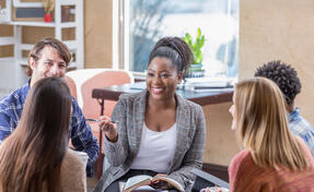 Counselor with young adults in a group conversation
