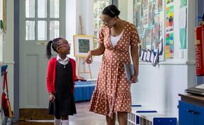 a school counselor talking to a girl student while walking