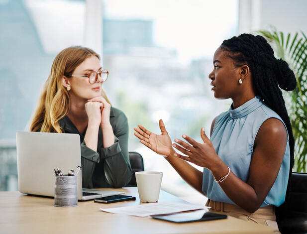 female human resources employee talking to a co-worker