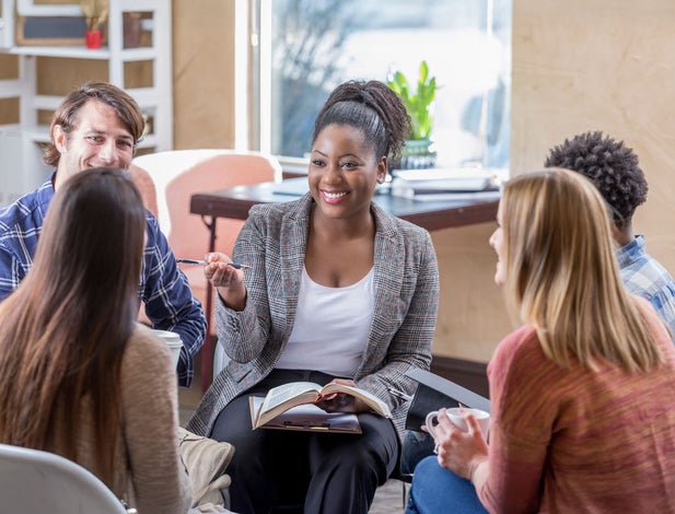 Counselor with young adults in a group conversation