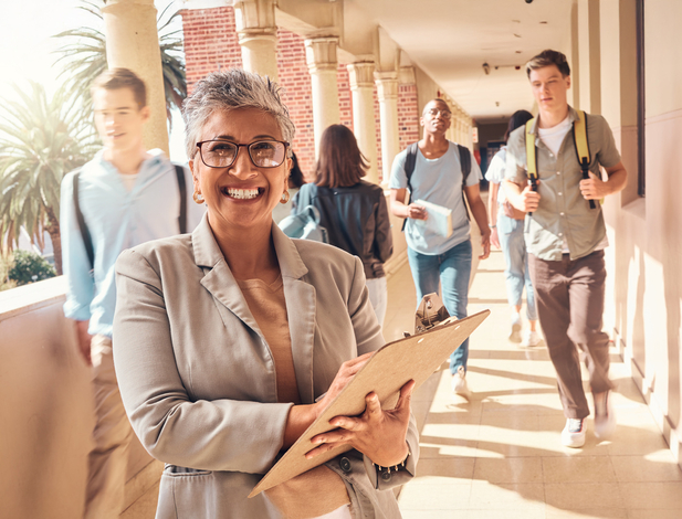 School principal in hallway with students