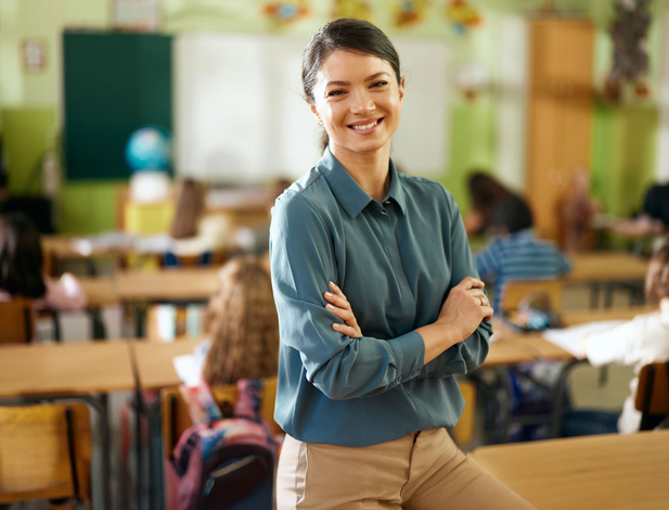 Elementary teacher posing in front of class