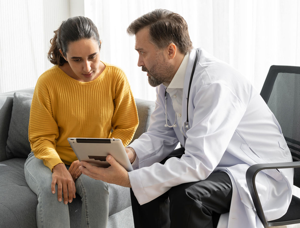 Doctor speaking Spanish to a patient