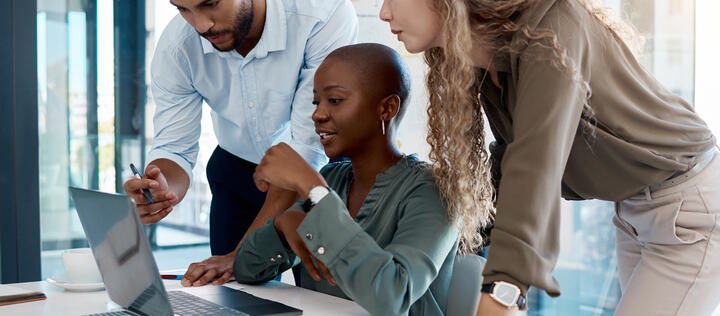 Team collaboration, online marketing and laptop planning for ideas, inspiration and strategy in startup company. Business people in diversity group working, meeting and discussion with internet tech