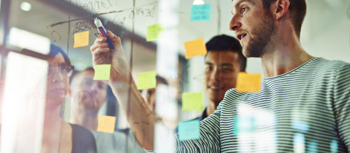 Marketing team brainstorming at the board