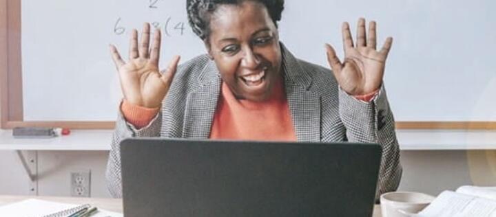 Happy teacher inspiring kids online