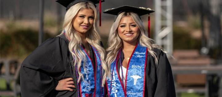 Class of 2022 nursing graduates Sonia and Homa Sher standing next to each other wearing their regalia.